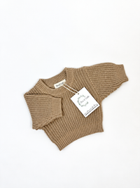 rye ribbed knit baby sweater with a folded sleeve, displayed on a clean white background with a paper brand tag attached.
